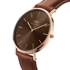 Classic St Mawes Amber Rose Gold watch featuring a sunray brown dial, slim rose gold case, minimalist markers, and a brown Italian Nappa leather strap, shown in a close-up angled view.