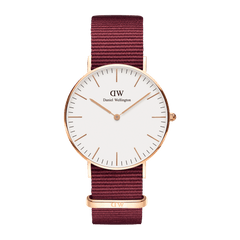 Classic Roselyn Rose Gold watch with a slim rose gold case, minimalist white dial, and a deep ruby red NATO strap, showcasing a refined and versatile design for women.