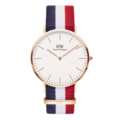 Classic Cambridge Rose Gold watch featuring a slim rose gold case, minimalist eggshell white dial, and a striped NATO strap in blue, white, and red for a modern, preppy look.