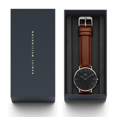 Classic St Mawes Black Silver watch with a black dial and brown leather strap, elegantly presented in a branded Daniel Wellington gift box.