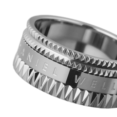 Close-up of the Elevation Ring Silver by Daniel Wellington, highlighting the geometric textured edges and polished engraved centre on the wide stainless steel band.
