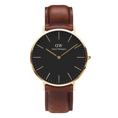 Classic St Mawes Gold watch featuring a matte black dial, gold-plated round case, minimalist hour markers, and a rich brown leather strap with a smooth finish.