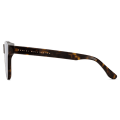 Side view of Ambler Bio-Acetate Dark Havana sunglasses showing the rich brown tortoiseshell frame and Daniel Wellington logo on the arm, highlighting the elegant and sustainable design.