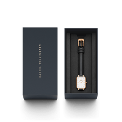Quadro Pressed Sheffield Rose Gold watch with a rectangular white dial and black leather strap, elegantly presented in a Daniel Wellington branded gift box.