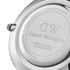 Back view of the Petite Cornwall Black Silver watch showing the engraved stainless steel case back with Daniel Wellington branding, water resistance rating, and unique serial number.