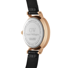 Close-up of the Petite Pressed Ashfield watch showing the engraved stainless steel case back, rose gold plating, and adjustable black mesh strap.
