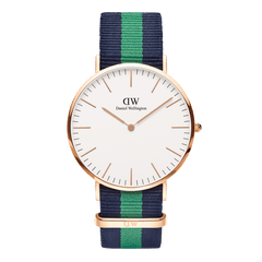 Classic Warwick Rose Gold watch with a slim rose gold case, minimalist eggshell white dial, and a navy and green striped NATO fabric strap. The design combines a refined look with a comfortable, adjustable fit suitable for both men and women.