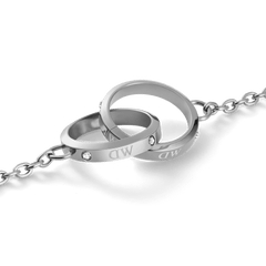 Close-up of the Classic Lumine Unity Silver necklace pendant, featuring two interlocking polished silver rings with subtle crystal accents on a fine chain, crafted from stainless steel for a modern, elegant look.