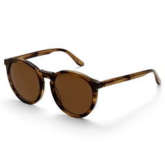 Bio-Acetate Arch Brown Demi sunglasses with a round brown demi frame, amber coloured lenses, and Daniel Wellington branding on the temples, shown at an angle to highlight the lightweight bio-acetate construction.