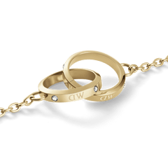 Close-up of the Classic Lumine Unity Gold necklace pendant, showing two polished gold interlocking rings with Preciosa® crystal detailing and a delicate chain.