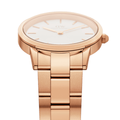 Detail view of the Iconic Link Rose Gold watch showing the brushed rose gold stainless steel three-link bracelet and slim case, with a minimalist eggshell white dial for a modern, elegant finish.