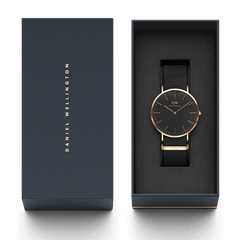 Classic Cornwall Black Rose Gold watch presented in a sleek Daniel Wellington gift box, featuring a black NATO strap and minimalist black dial with rose gold accents.