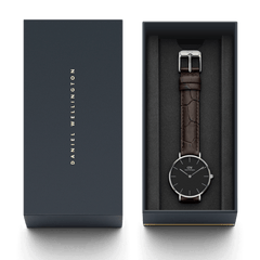 Petite York Black Silver ladies watch presented in a Daniel Wellington gift box, featuring a minimalist black dial, slim silver case, and croc-embossed dark brown leather strap.