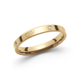A slim gold ring with a polished finish, featuring engraved branding and sparkling crystal accents spaced evenly around the band.
