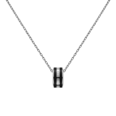 Close-up of the Emalie Necklace Silver Black showing a polished silver chain with a bold black enamel pendant, featuring engraved branding for a sleek and modern finish.
