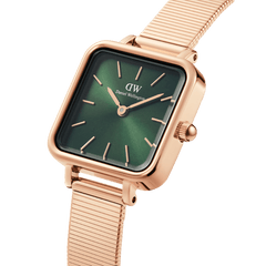 Quadro Studio Green Rose Gold watch with a polished rose gold square case, emerald green dial, minimalist hour markers, and a sleek piano link mesh strap, shown in a close-up angled view.