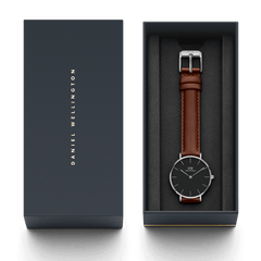 Petite St Mawes Black Silver ladies watch with a black dial and brown leather strap, elegantly presented in a branded Daniel Wellington gift box.