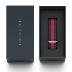 Oxford Strap Silver NATO style watch strap in navy blue and red stripes, presented in a premium Daniel Wellington gift box with a polished silver buckle.
