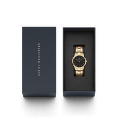 Daniel Wellington Iconic Link Black Gold watch presented in a premium branded gift box, featuring a gold stainless steel bracelet and minimalist black dial.