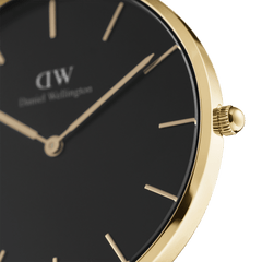 Close-up of the Petite Evergold Black gold watch, highlighting the slim gold case, minimalist black dial, and gold hour markers for an elegant, contemporary look.