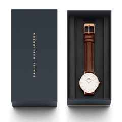 Petite St Mawes rose gold women’s watch with a brown leather strap, presented in a sleek Daniel Wellington gift box, ideal for gifting or adding to your collection.