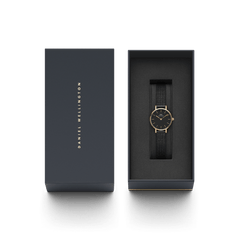 Petite Pressed Ashfield ladies watch with a rose gold case and black mesh strap, presented in a sleek Daniel Wellington gift box, ideal for gifting or adding to a collection.