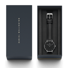 Petite Sheffield Black Silver watch presented in a sleek Daniel Wellington gift box, featuring a minimalist black dial and slim black leather strap for a refined, elegant look.
