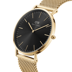 Classic Mesh Onyx Gold watch with a black sunray dial, slim gold hour markers, and a gold stainless steel mesh strap, shown in a close-up angle to highlight its elegant and modern design.