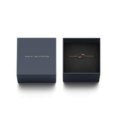 Elan Unity Bracelet Rose Gold presented in a navy Daniel Wellington gift box, featuring two interlocking rings on a delicate rose gold chain.