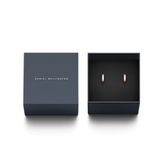 Classic Lumine Rose Gold earrings with crystal accents, presented in an elegant Daniel Wellington gift box with a dark navy lid and minimalist branding.