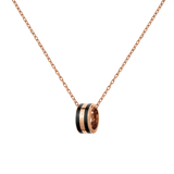 Rose gold chain necklace featuring a circular black enamel pendant with engraved detailing, showcasing a minimalist and modern design suitable for everyday wear or layering with other jewellery.