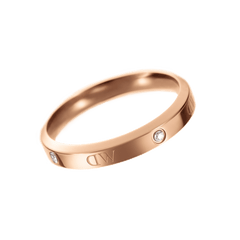 Classic Lumine Ring Rose Gold displays a slim, polished rose gold band with alternating crystal stones and logo etchings, designed for understated elegance and versatile styling.