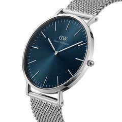 Classic Mesh Arctic Silver watch featuring a blue sunray dial, slim stainless steel case, and bright silver mesh strap, shown at an angle to highlight its minimalist design and modern elegance.