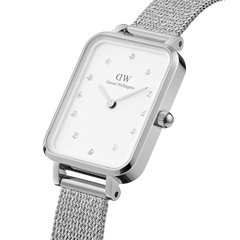 Quadro Lumine Pressed Sterling showcases a rectangular stainless steel case, eggshell white dial with crystal indexes, and a silver mesh bracelet, highlighting its minimalist and elegant design for women.