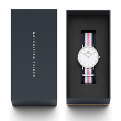 Classic Southampton Silver watch with a striped blue, pink, and white NATO strap presented in a sleek Daniel Wellington gift box, highlighting its minimalist eggshell white dial and refined packaging, ideal for gifting or special occasions.