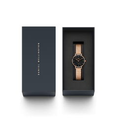 Petite Lumine Pressed Piano Black MoP Rose Gold ladies watch presented in a sleek Daniel Wellington gift box, featuring a rose gold pressed piano link strap and a black mother of pearl dial with crystal markers.