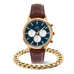Daniel Wellington Iconic Chronograph Panda watch with a blue dial, gold accents, and brown leather strap, paired with a gold Ellipse Cuban Chain Bracelet for men.