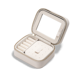 Travel Jewellery Box White with a soft white exterior, gold zip, and plush interior, featuring ring rolls, compartments for earrings and necklaces, a pouch pocket, and a built-in mirror for organised jewellery storage on the go.