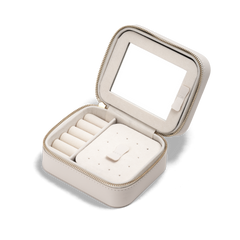 Travel Jewellery Box White with a soft white exterior, gold zip, and plush interior, featuring ring rolls, compartments for earrings and necklaces, a pouch pocket, and a built-in mirror for organised jewellery storage on the go.