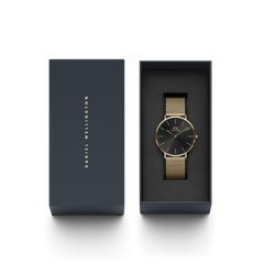 Classic Mesh Onyx Gold watch with a black sunray dial and gold mesh strap, elegantly presented in a dark gift box with Daniel Wellington branding, ideal for gifting or special occasions.
