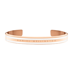Emalie Slim Bracelet Rose Gold features a slender rose gold cuff with satin white enamel accents and the Daniel Wellington logo engraved on the front, offering a minimalist and elegant jewellery option for everyday wear.