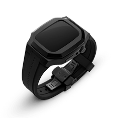Switch Black Black Apple Watch case with a matte black brushed stainless steel frame, geometric contours, and an integrated FKM rubber strap featuring a deployment clasp, suitable for Series 6, 5, 4, and SE models.
