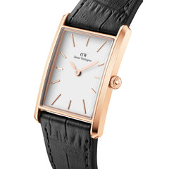 Rectangular rose gold watch with a white dial, slim case and black crocodile-embossed leather strap, highlighting its elegant and modern design.