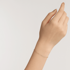 A slim rose gold Flat Chain Bracelet RG with a minimalist chain design, worn on a wrist, showing its delicate and elegant fit suitable for everyday wear.