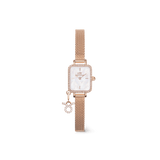 Rose gold ladies watch with a rectangular crystal-framed case, white mother of pearl dial, and an interchangeable crystal zodiac charm on an adjustable mesh strap.