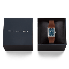 Daniel Wellington Bound Light Brown Arctic Guilloché Silver men’s watch with a rectangular silver case, blue guilloché dial, and brown leather strap, presented in an elegant branded gift box.