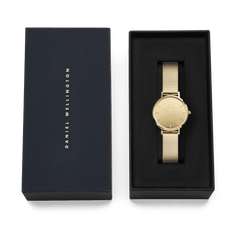 Daniel Wellington Petite Reflection Gold watch with a gold mesh strap and mirror dial, elegantly presented in a black branded gift box, ideal for gifting or special occasions.