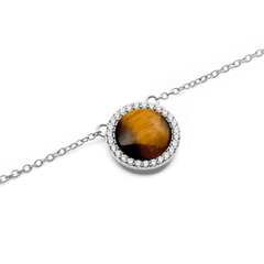 Close-up of the Audrey Necklace Tiger Eye Silver pendant, showing the domed tiger eye stone surrounded by a halo of white cubic zirconia crystals on a polished silver chain.