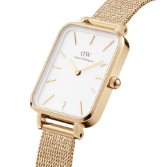 Quadro Pressed Evergold Gold watch with a rectangular gold case, crisp white dial, minimalist gold markers, and a fine gold mesh bracelet, shown in a close-up angle to highlight its elegant details.