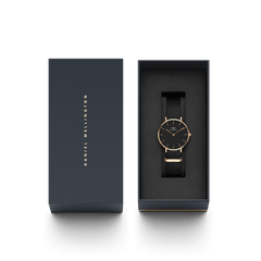 Petite Cornwall Black Rose Gold women’s watch with a black NATO strap and rose gold case, elegantly presented in a branded Daniel Wellington gift box.